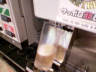 The beer machine filling the tilted glass